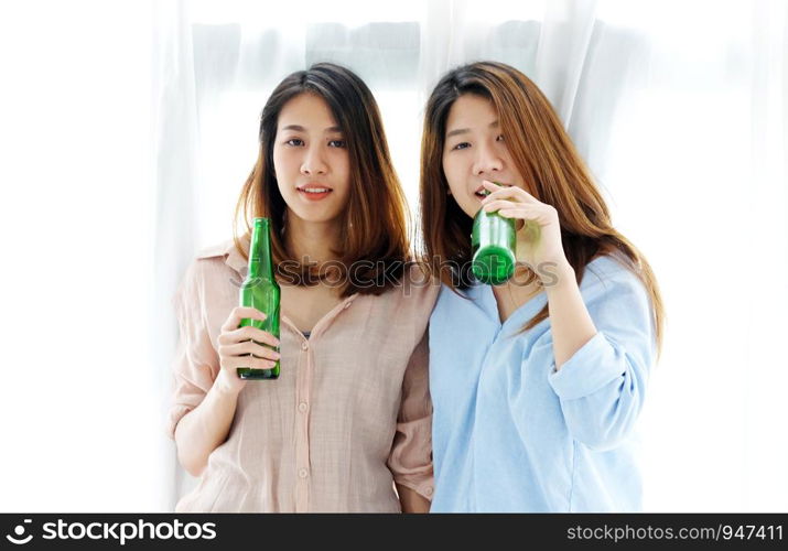 Two asian women drinking beer at party, celebration, LGBT couple, lifestyle
