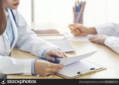 Two asian women hand doctors meeting write prescription medical clinic. Doctor discuss using laptop write note. Close up hands of two women doctor medical lab discussing together healthcare teamwork