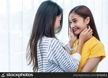 Two Asian women looking at each others in home. People and lifestyles concept. LGBT pride and lesbian theme.