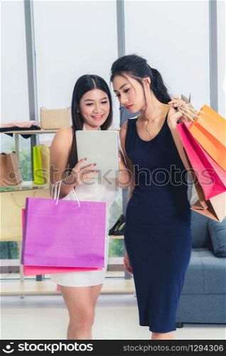 Two Asian women shopping at retail shop in the shopping mall. Modern trade lifestyle.