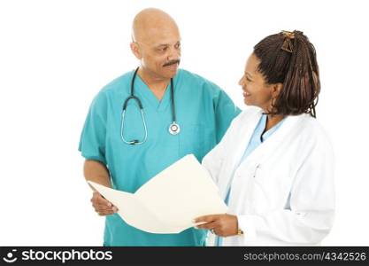 Two attractive, African American doctors discussing a patient&rsquo;s medical chart. Isolated on white.