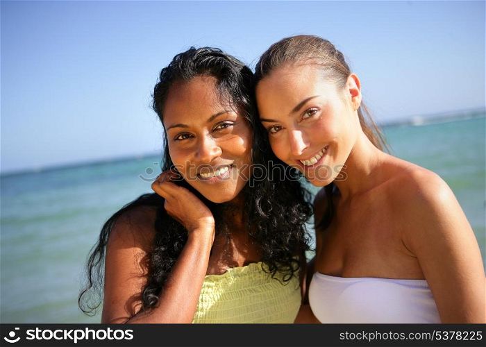 Two attractive female friends stood at the beach