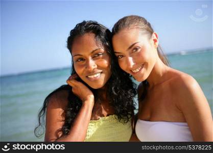 Two attractive female friends stood at the beach