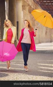 Two attractive girlfreinds with the colorful umbrellas