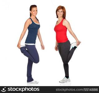 Two attractive girls stretching isolated on white background