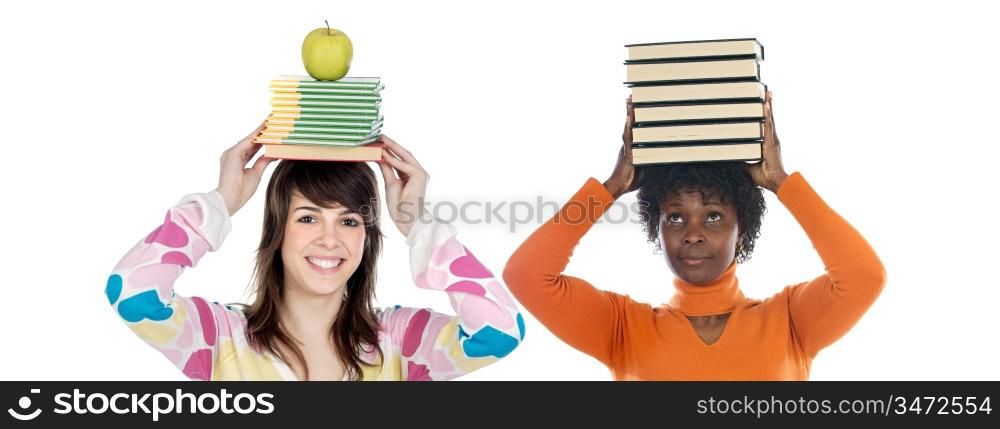 Two attractive girls with books on the head isolated over white