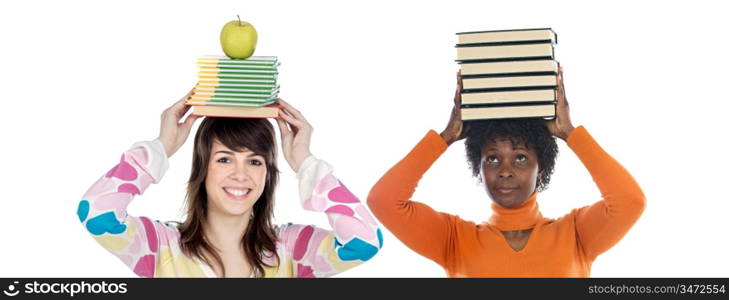 Two attractive girls with books on the head isolated over white