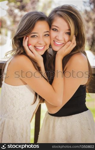 Two Attractive Mixed Race Girlfriends Smile Outdoors.