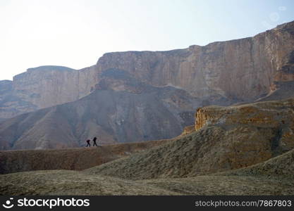 Two backpackers walk to the top of mount Hod Akev