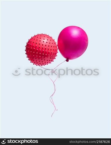 Two balloons with ropes that form a heart isolated on a blue background. The concept of Valentine?s Day and love. Upright rectangle layout. Minimal.. Two balloons with ropes that form a heart isolated on a blue background. The concept of Valentine?s Day and love.