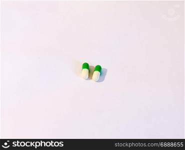 two basic generic pills on a white background white and green drugs stock photo for medical and healthcare