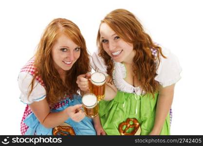 two bavarian girls with beer and pretzels. two bavarian girls with beer and pretzels on white background