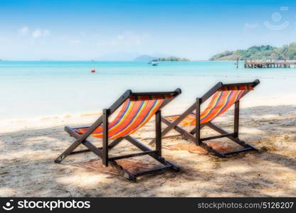 Two beach chairs on idyllic tropical sand beach.