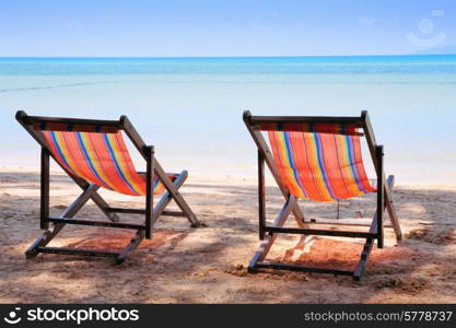 Two beach chairs on idyllic tropical sand beach.