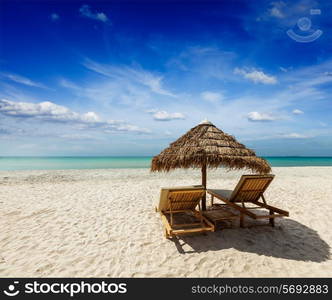 Two beach lounge chairs under tent on beach. Sihanoukville, Cambodia