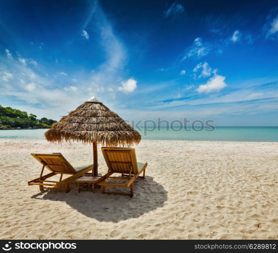 Two beach lounge chairs under tent on beach. Sihanoukville, Cambodia