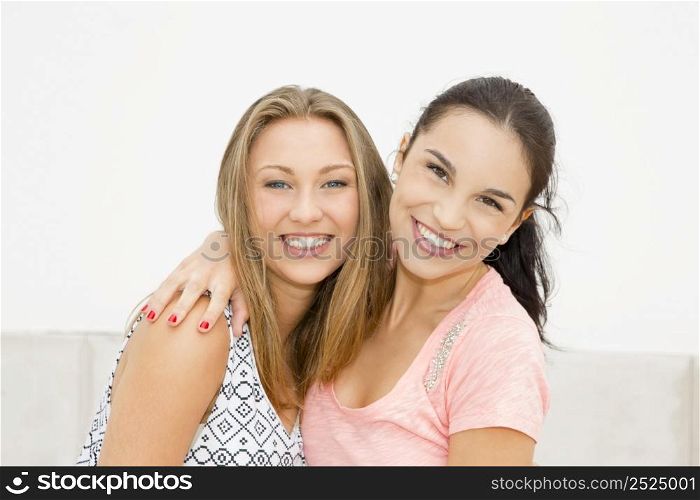Two beautiful and happy teenage friends in the school