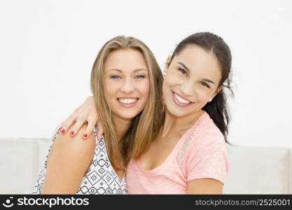 Two beautiful and happy teenage friends in the school