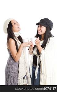 Two beautiful asian women laughing and drinking coffee