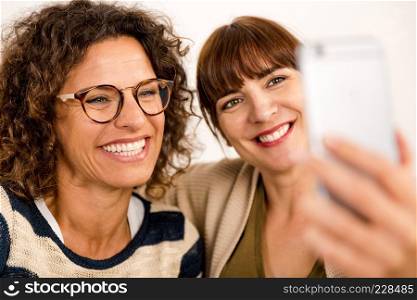 Two beautiful firends at home making  a selfie