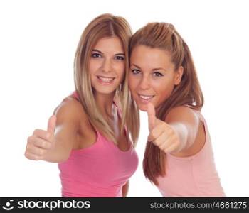 Two beautiful friends in pink saying Ok isolated on a white background
