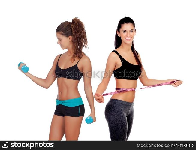 Two beautiful girls in the gym training isolated on a white background