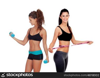 Two beautiful girls in the gym training isolated on a white background