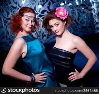 two beautiful girls posing in a club