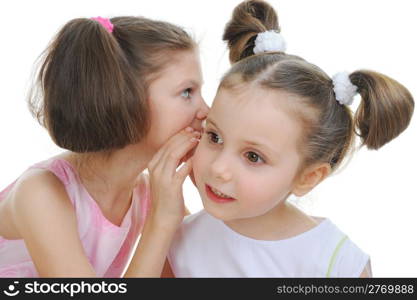 Two beautiful girls telling secret. Isolated on white background