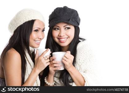 Two beautiful smiling asian women drinking coffee