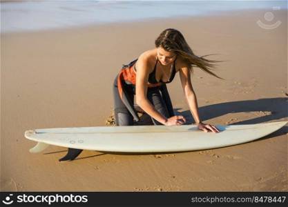 Two beautiful surfer girls at the beach getting ready for surfing