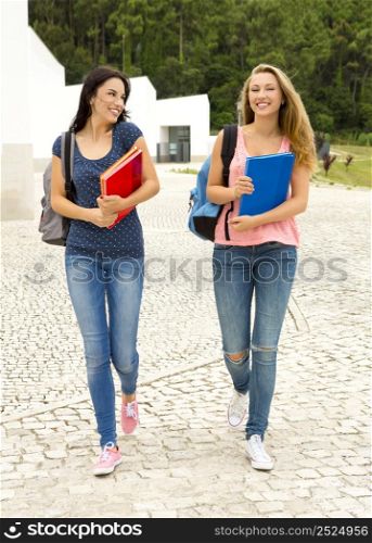 Two beautiful teenage students walking together in the school