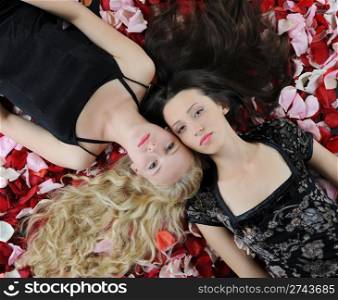 Two beautiful women in rose petals