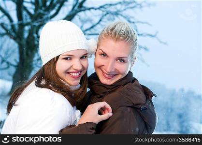 Two beautiful women in winter clothing outdoors