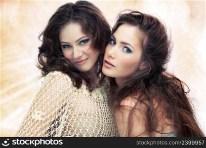 Two beautiful women on shining background