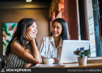 Two beautiful women talking everything together at coffee shop cafe