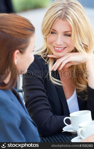 Two Beautiful Young Women Having Coffee