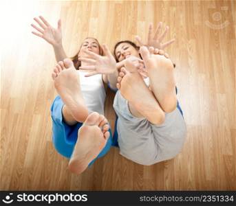 Two beautiful young women having fun and moving the Hands and Feet