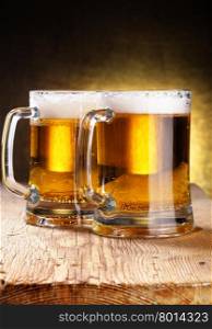 Two beer mugs close-up on wooden table