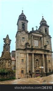 Two Bell towers and facade of San Francisco church and Francis of Assisi sculpture near in Santiago de Compostela, Spain.