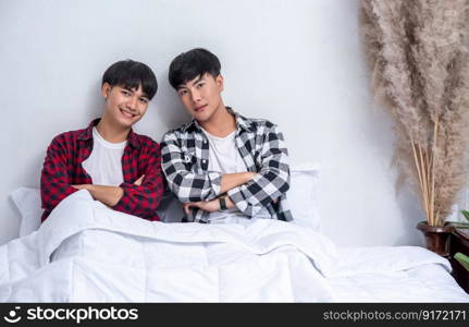 Two beloved young men slept in bed together.