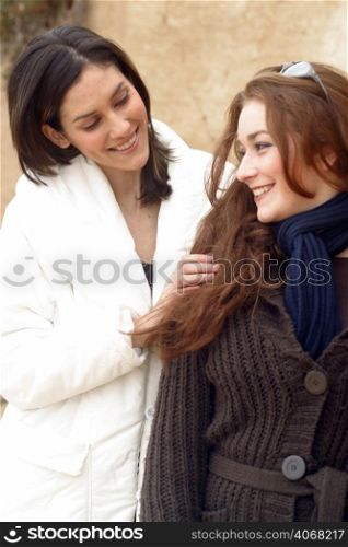 Two best friends chat and smile to each other.