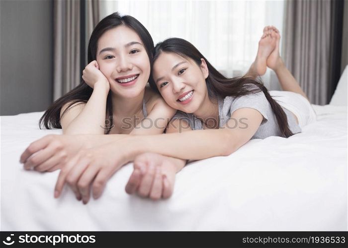 Two best friends lying on the bed
