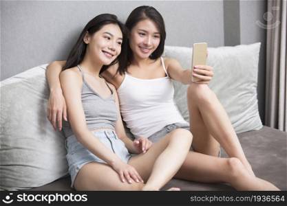Two best friends taking selfies on a mobile phone