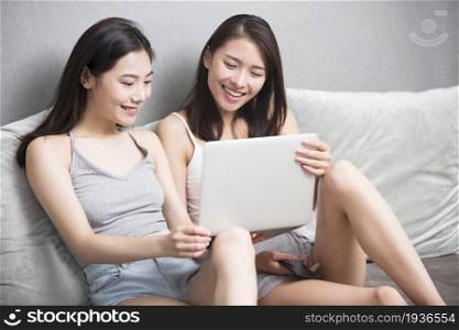 Two best friends using a computer together