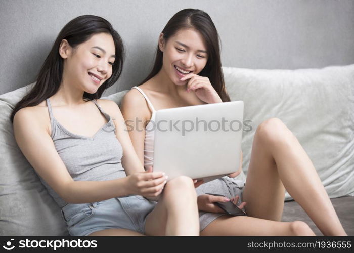 Two best friends using a computer together