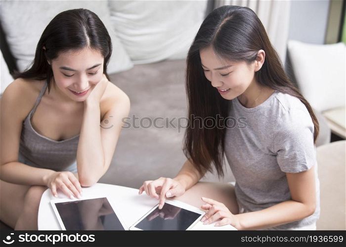 Two best friends using a laptop computer together