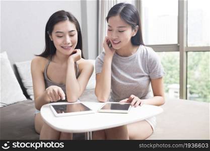 Two best friends using a laptop computer together