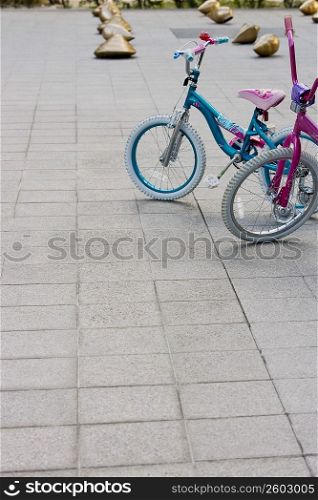 Two bicycles parked on a road