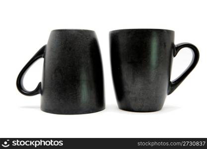 Two black coffe cups up and down isolated